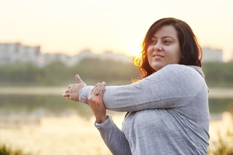 Woman stretching before exercising outside.
