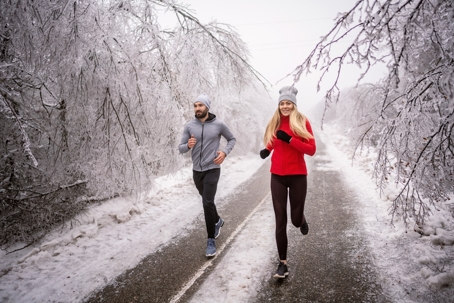 Couple going on a jog down a snowy side street. | Soza Weight Loss