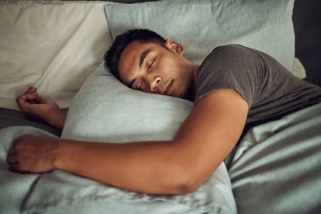 Man sleeping comfortably in bed.