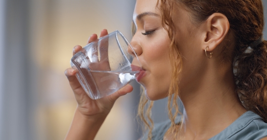 Woman drinking a glass of water.